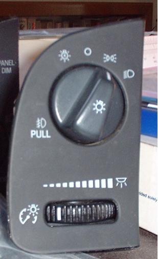 1997 Ford Crown Victoria - This part is a headlight switch assembly with a pull knob and a dimmer dial for interior lighting.