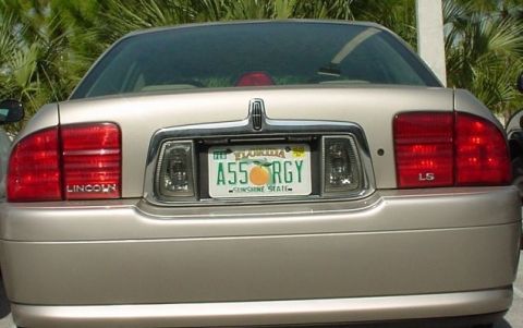 2000 Jeep Cherokee - The rear of a gold Lincoln LS sedan is shown, its distinctive taillights and license plate.