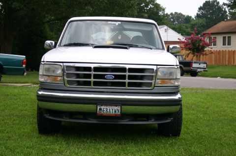 1994 Ford Bronco - Front view of a white 1994 Ford Bronco parked on a grassy lawn.
