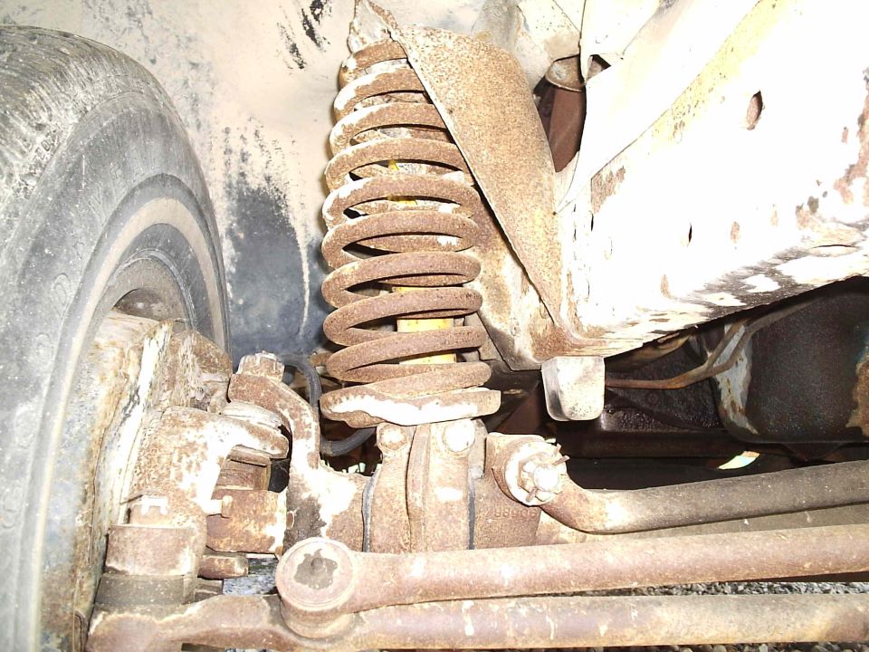 Front suspension coil spring and tire of a 1979 Ford F-150
