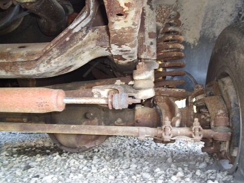 1979 Ford F-150 - Close-up of the heavily rusted front suspension and steering components of a 1979 Ford F-150.