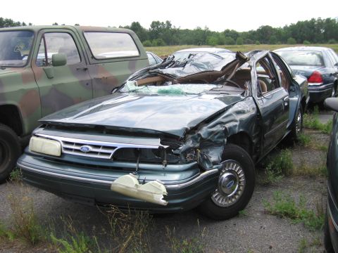 1991 Ford LTD Crown Victoria - Frontal damage is extensive on this 1991 Ford Crown Victoria LTD, seen in a junkyard.
