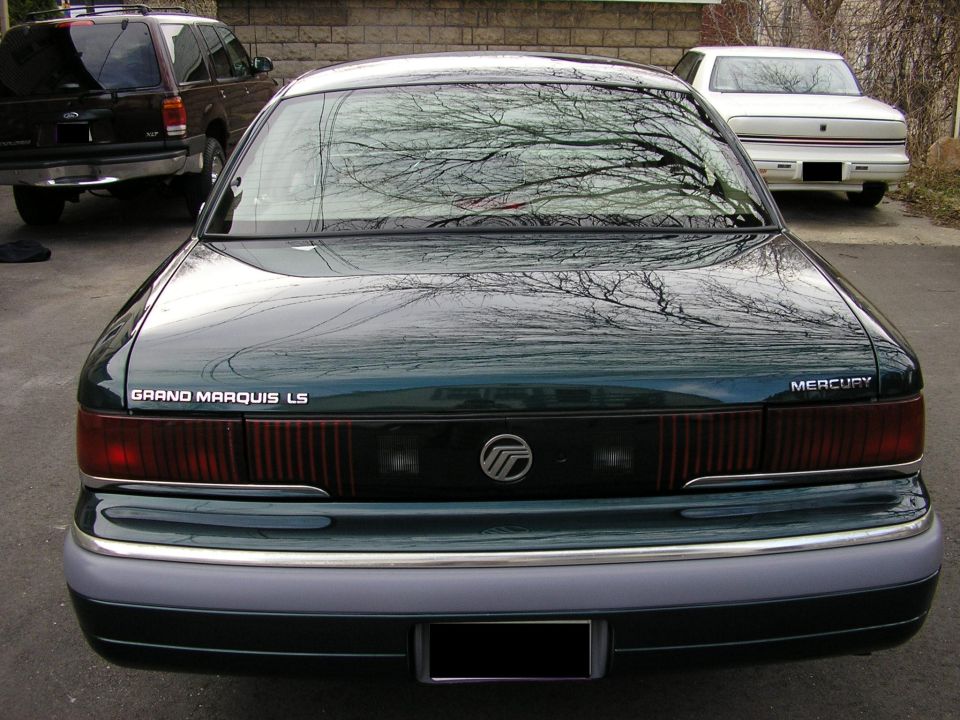 Rear of dark green Mercury Grand Marquis LS sedan with full-width taillights