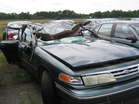 1991 Ford LTD Crown Victoria - This 1991 Ford Crown Victoria LTD has suffered significant damage, including a collapsed roof and broken windshield.
