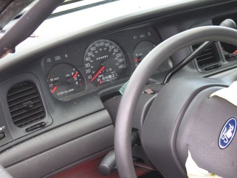 1991 Ford LTD Crown Victoria - Interior view of a 1991 Ford Crown Victoria LTD, showing the dashboard gauges and steering wheel with the Ford logo.
