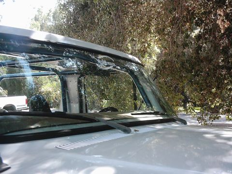 1978 Ford Bronco - Close-up of a 1978 Ford Bronco's windshield and roofline, with another vehicle in the background.