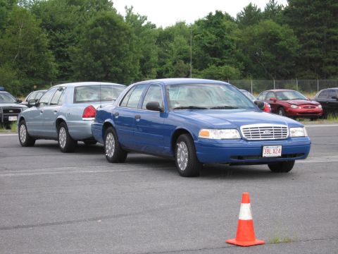 1991 Ford LTD Crown Victoria - A blue Ford Crown Victoria is parked in a lot with other vehicles, including a light blue Crown Victoria behind it.