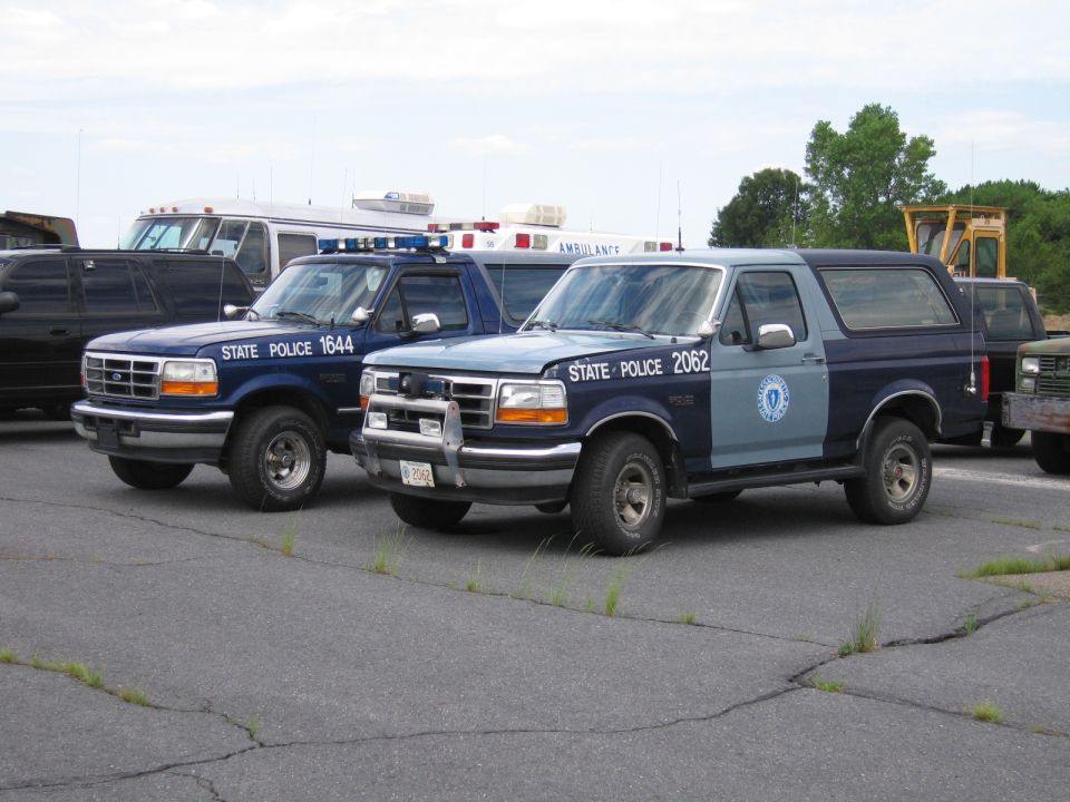 Two-tone blue and grey Ford Bronco police SUV, front 3/4 view. "STATE POLICE 2062" text visible