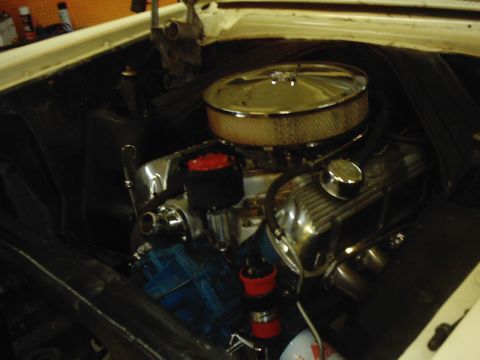 1978 Ford Bronco - Close-up view of a vehicle's engine bay, polished chrome components and a prominent air filter.