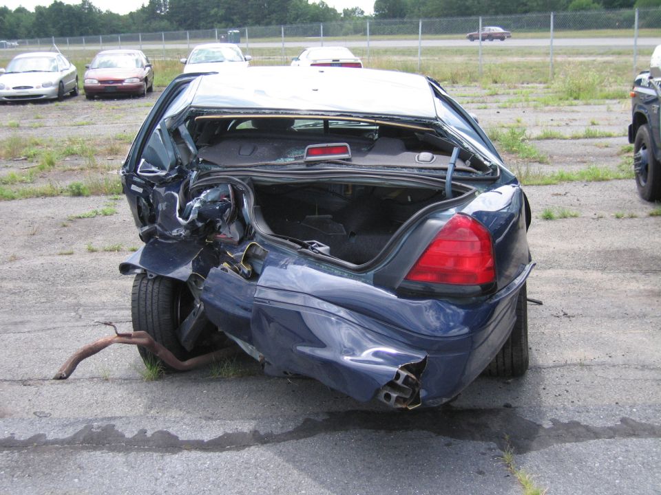 1991 Ford Crown Victoria LTD with severe rear-end damage, trunk open