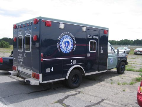 1991 Ford LTD Crown Victoria - Massachusetts State Police ambulance with "Special Emergency Response Team" markings is viewed from the rear-side.