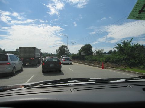 1991 Ford LTD Crown Victoria - A view from inside a vehicle shows a traffic jam on a sunny day with a silver minivan, black hatchback, and white sedan.