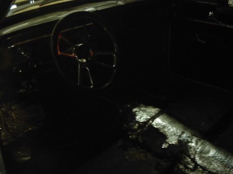 1978 Ford Bronco - The interior of a vehicle is shown, a steering wheel and a covered center console.