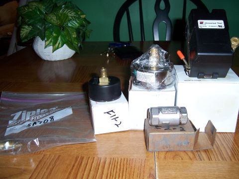 1983 Ford Bronco - Collection of air compressor parts including a pressure switch, gauge, and various fittings.