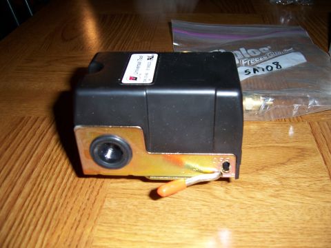 1983 Ford Bronco - This black pressure switch features a gold mounting bracket and an orange wire, likely for an air compressor or similar application.