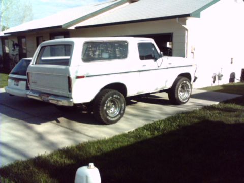1978 Ford Bronco - This white 1978 Ford Bronco is parked in a driveway next to another vehicle.