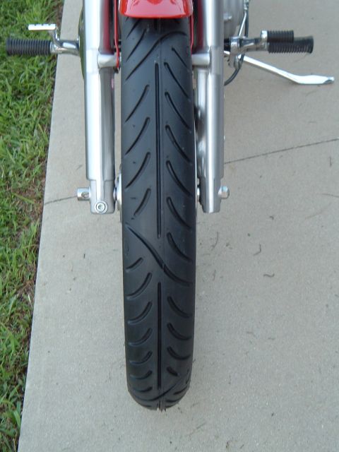 2002 Harley-Davidson Sportster Custom - Close-up of a motorcycle's front tire and suspension components.