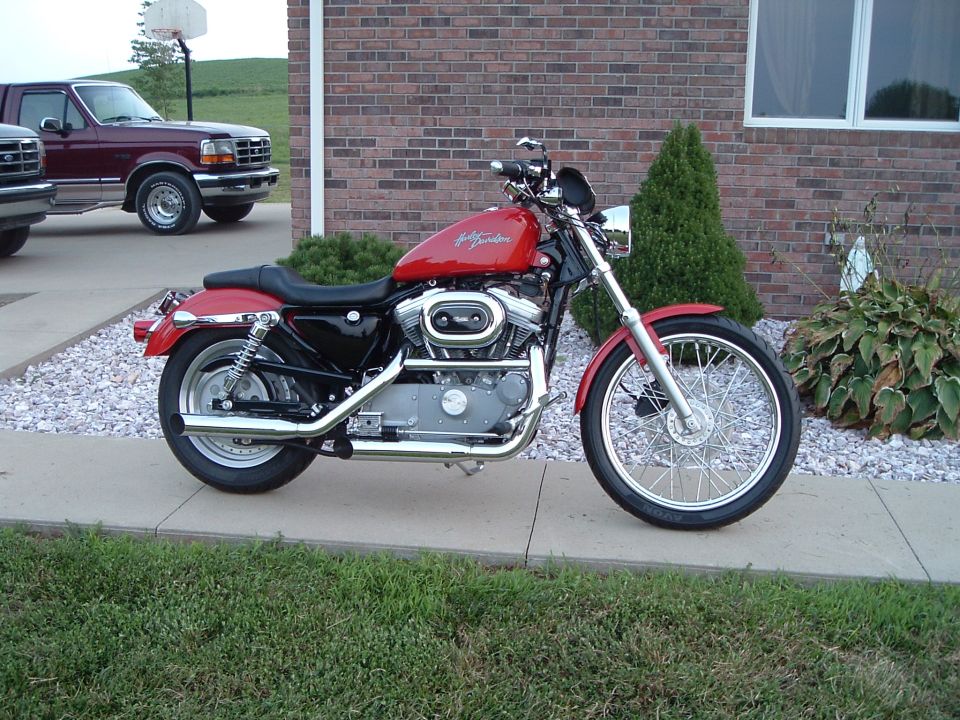 Red Harley-Davidson motorcycle parked on a driveway