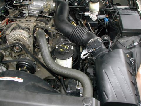 2000 Ford Crown Victoria - Close-up view of a vehicle's engine bay, showing various components and wiring.