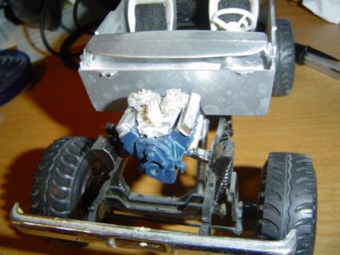 1979 Ford Bronco - Model car engine and chassis assembly with a chrome bumper visible.