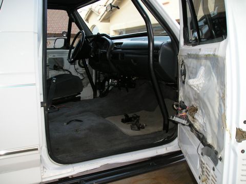 1993 Ford Bronco - Interior view of a 1993 Ford Bronco, with the driver's side door panel removed for sound dampening work.