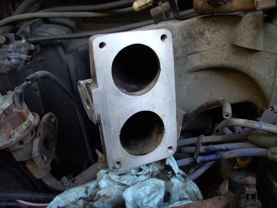 There's the EGR hanging out of the way.  I cleaned just around the mouth of the two throttle plenum openings and the EGR passageway in the intake and EGR itself.