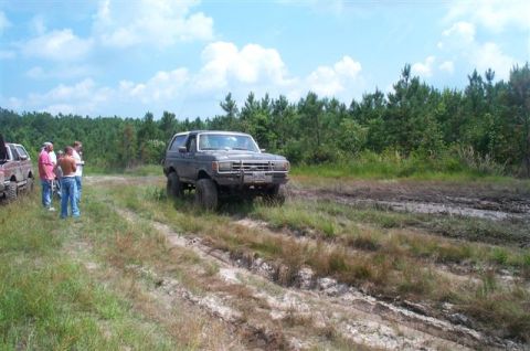 1988 Ford Bronco - 1988 Ford Bronco off-roading in a muddy field with friends.