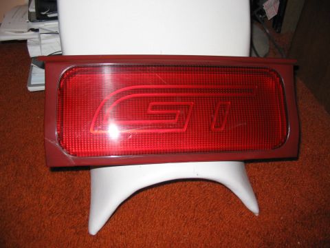 1994 Ford Probe - A red taillight assembly with a GT emblem is shown, mounted on a white stand.