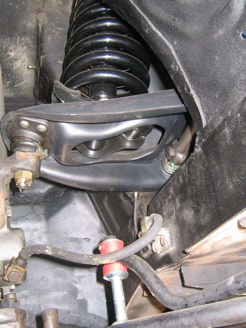 1969 Ford Ranchero - Underside view of vehicle suspension parts, including a coil spring and control arm.