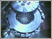 1981 Ford Bronco - Close-up of a vehicle's clutch assembly, showing the pressure plate and disc components.