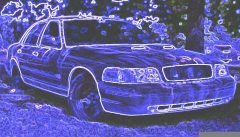 2001 Ford Crown Victoria - The front end of a 2001 Ford Crown Victoria is visible, with another car parked behind it.