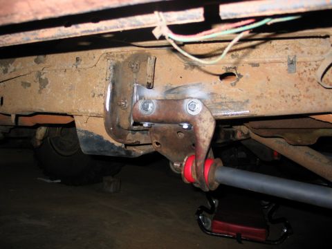 1995 Ford Bronco - Undercarriage view shows modifications to the suspension system with new red bushings and a gray sway bar.
