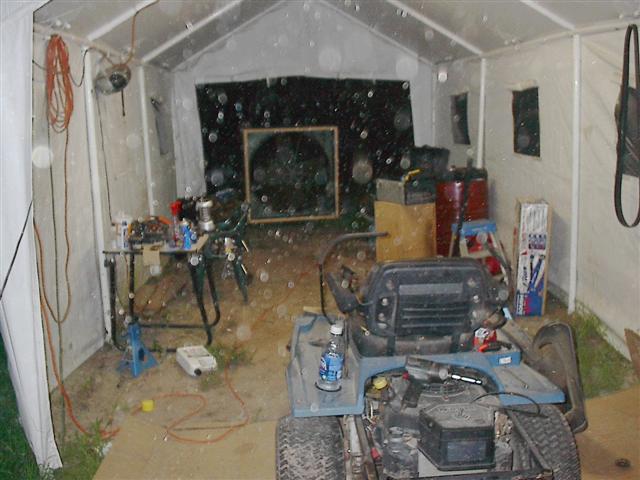 Lawn mower interior in a tent with tools and supplies
