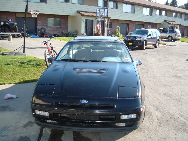 Black 1989 Ford Probe coupe with pop-up headlights and sunroof, front view
