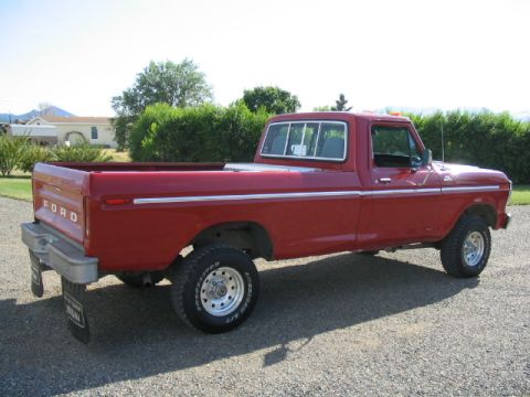 1979 Ford F-150 - This red 1979 Ford F-150 pickup truck is shown from a 3/4 front angle, highlighting its classic body style.