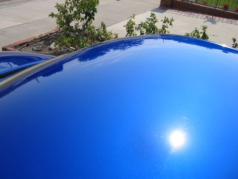 1990 Ford Probe - Shiny blue car roof with "SUPERMOTORS" logo visible.