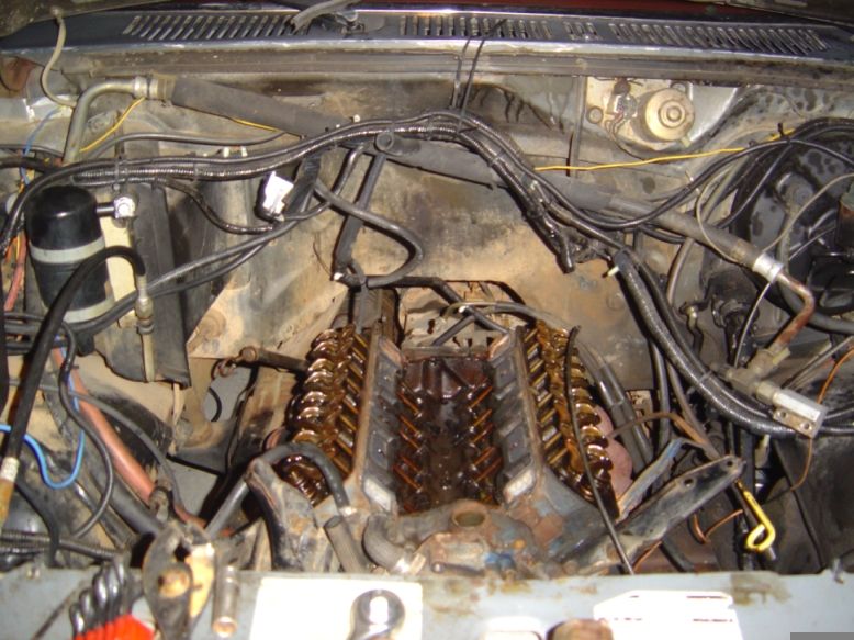 V8 engine bay with intake manifold removed, exposing rocker arms, pushrods and open lifter valley
