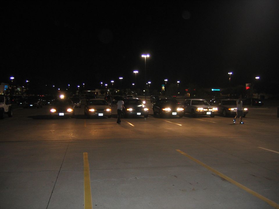2000 Ford Crown Victoria front view at night, headlights on, showing grille and hood