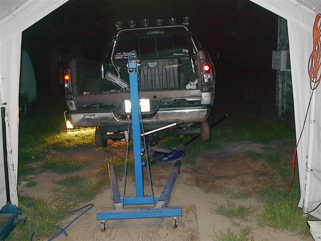 1997 Dodge 1500 pickup truck, rear view, dark color, under a tent, with engine hoist