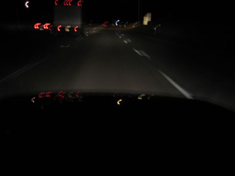 1985 Ford Mustang - Driving at night, the dashboard and road ahead are visible with blurred lights.