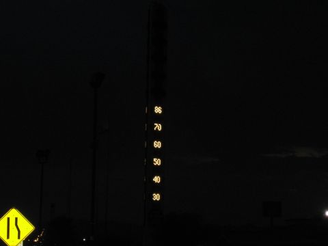 1985 Ford Mustang - A nighttime scene shows a vertical illuminated display with speed markings, including 86, 70, 60, 50, 40, and 30.