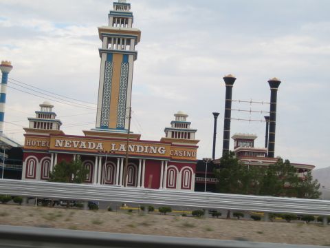 1985 Ford Mustang - The Hotel Nevada Landing Casino features unique architecture with colorful towers and prominent signage.
