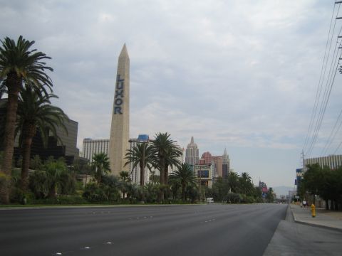1985 Ford Mustang - A view of the Luxor hotel and other Las Vegas Strip buildings under a cloudy sky.
