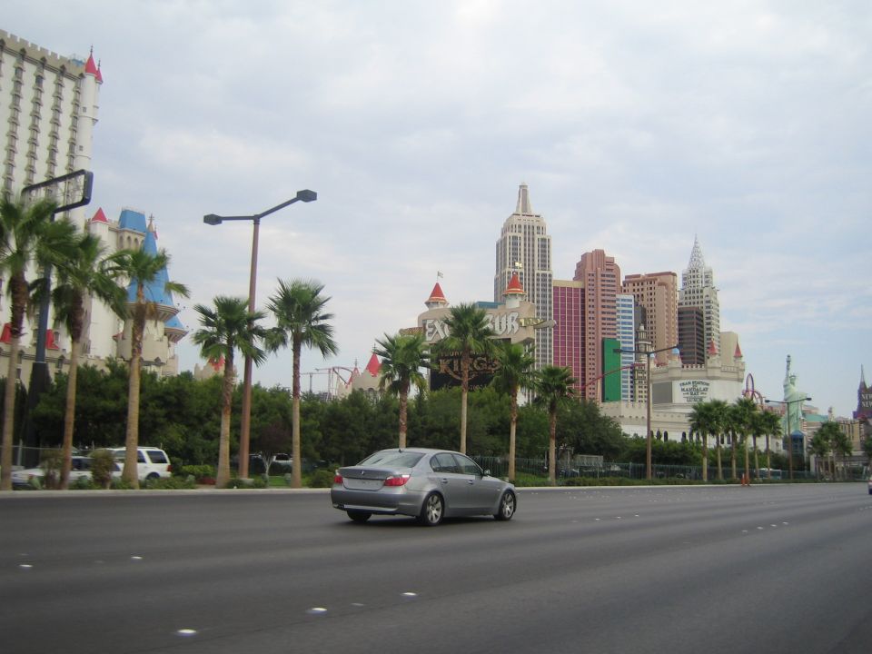 Silver sedan from rear view driving on road with Las Vegas hotels