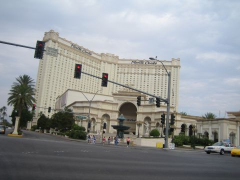 1985 Ford Mustang - Street view of the Monte Carlo hotel and casino in Las Vegas, with cars and traffic lights visible.