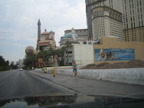 1985 Ford Mustang - A woman jogs past the Aladdin hotel and casino on the Las Vegas Strip, with the Eiffel Tower replica visible.