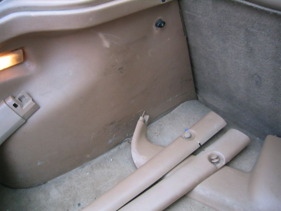 tan interior trim pieces and carpeted area inside a vehicle