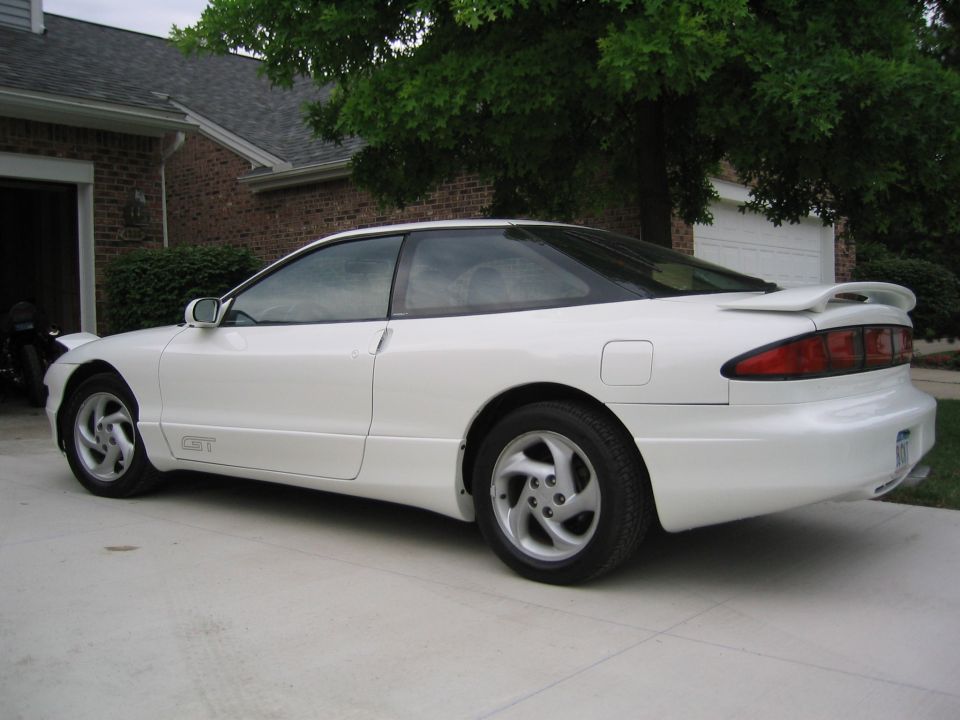 White coupe with a rear spoiler and 'GT' badging on the side