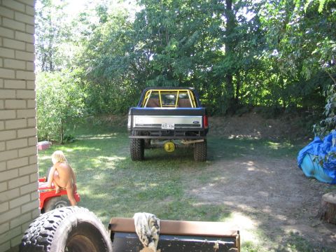 1986 Ford Bronco - This lifted 1986 Ford Bronco is viewed from the rear, a yellow roll cage and aftermarket bumper.