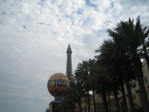 1985 Ford Mustang - A view of the Eiffel Tower replica and a hot air balloon in Las Vegas, with palm trees in the foreground.